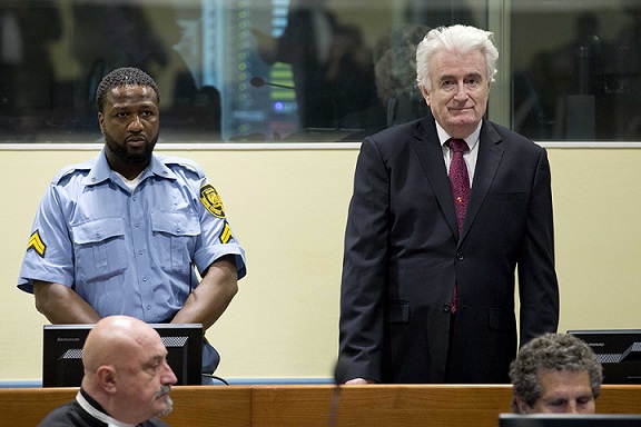 epa07450691 Former Bosnian Serb leader Radovan Karadzic (R) enters the court room of the Former Bosnian Serb leader Radovan Karadzic (R) enters the court room of the International Residual Mechanism for Criminal Tribunals in The Hague, Netherlands, 20 March 2019. Nearly a quarter of a century since Bosnia's devastating war ended, Karadzic is set to hear the final judgment on whether he can be held criminally responsible for unleashing a wave of murder and destruction. United Nations appeals judges will on Wednesday rule whether to uphold or overturn Karadzic's 2016 convictions for genocide, crimes against humanity and war crimes, as well as his 40-year sentence.  EPA-EFE/PETER DEJONG / POOL